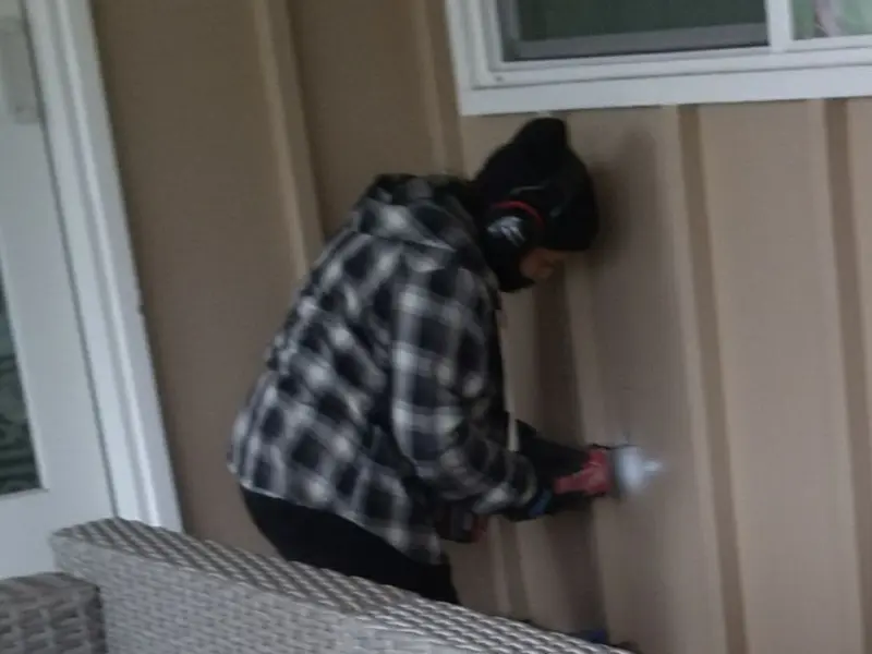 Professional electrician installing an exterior outlet in Bagley